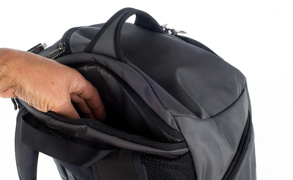 A person reaching into the Techonaut 30's open laptop compartment.